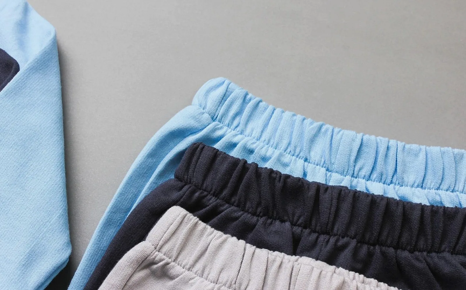 Close-up of baby clothing showcasing soft cotton fabric in pastel hues. Perfect for fashion blogs.