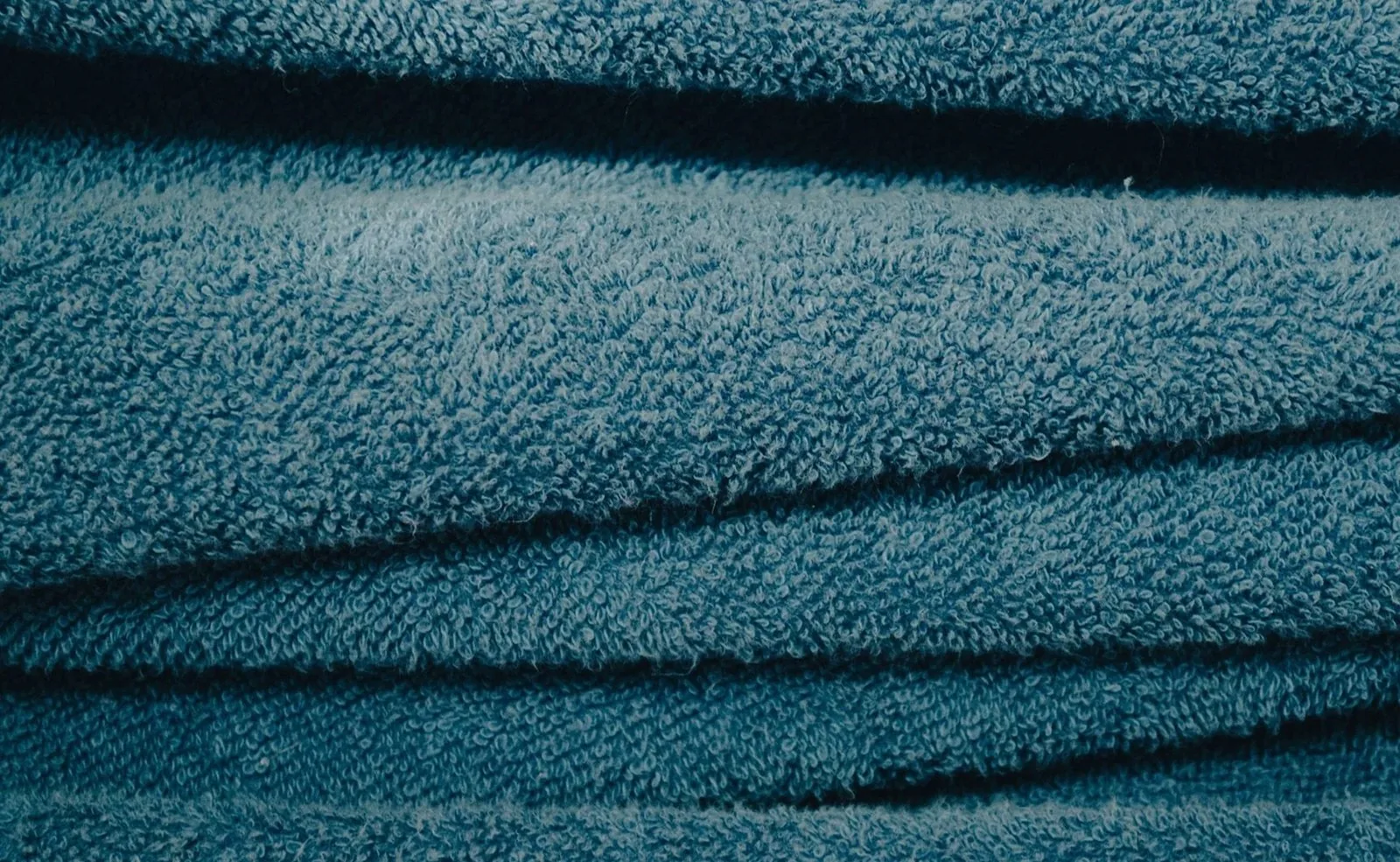 Detailed view of soft blue towels showcasing texture and fabric pattern.